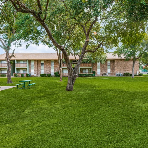 Love Where You Live large area of green grass and picnic table